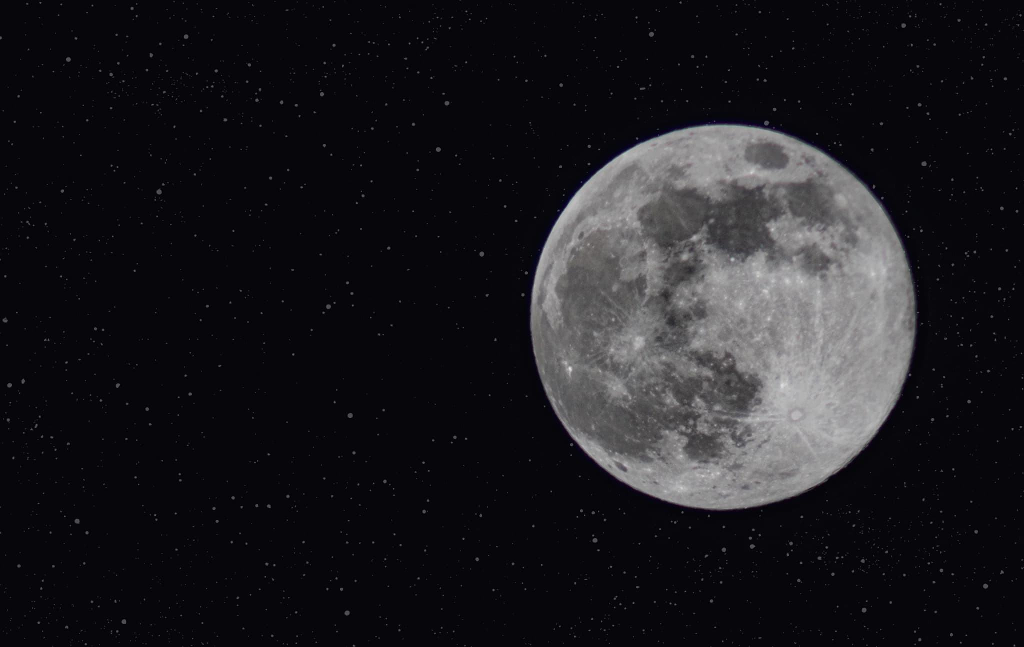 Detailed full moon against a deep black star field